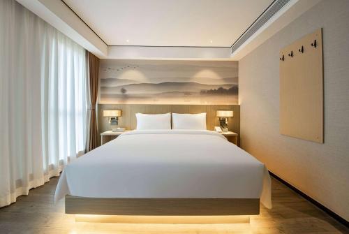 Imagen de la habitación del Hotel Ramada Encore by Wyndham Kunming Guandu. Foto 13