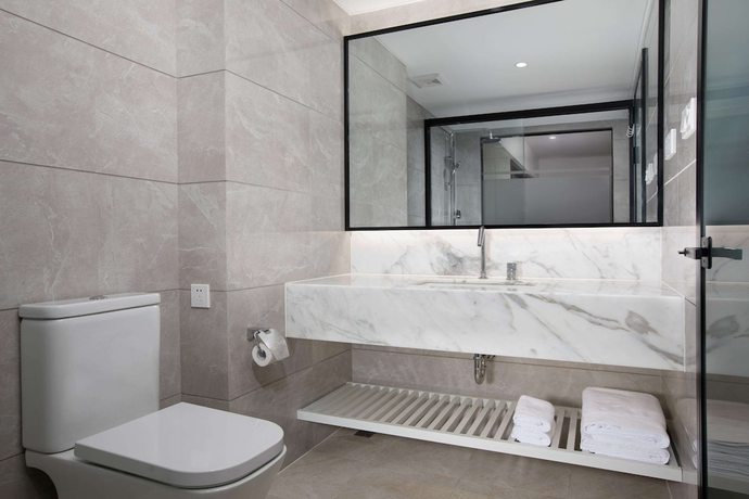 Imagen de la habitación del Hotel Ramada Encore by Wyndham Qionghai Downtown. Foto 12