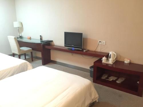 Imagen de la habitación del Hotel Ramada Encore by Wyndham Wuhan Int'l Conference Center. Foto 12
