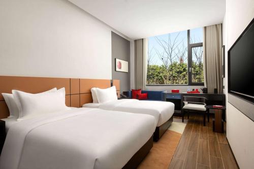 Imagen de la habitación del Hotel Ramada Encore by Wyndham Xishuangbanna Jinghong. Foto 12