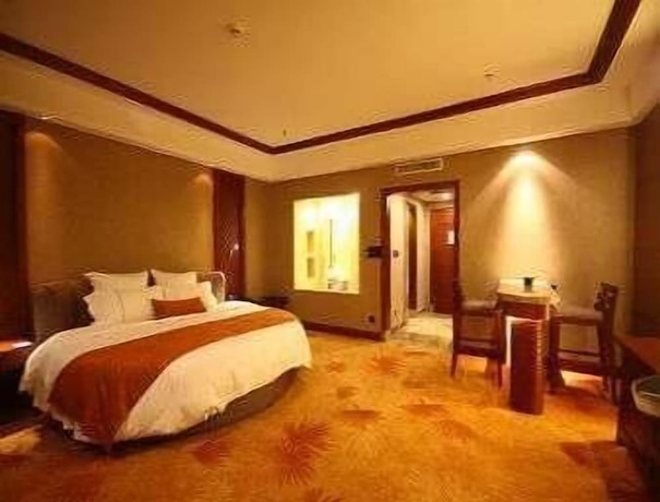 Imagen de la habitación del Hotel Ramada Plaza By Wyndham Xishuangbanna South. Foto 3