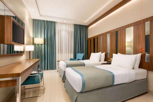 Imagen de la habitación del Hotel Ramada by Wyndham Makkah Zad Al Tayseer. Foto 16