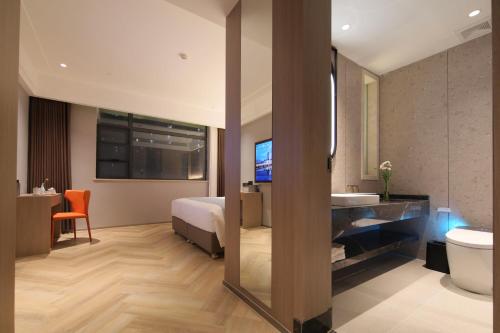 Imagen de la habitación del Hotel Ramada by Wyndham Wuhan Wangjiawan. Foto 13