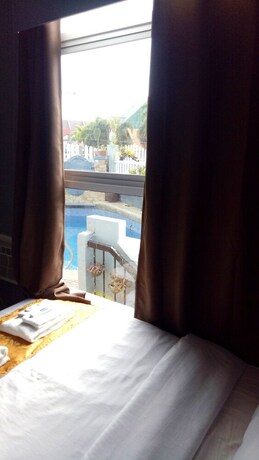 Imagen de la habitación del Hotel RedDoorz Premium at THE GRAND PENINSULA SUITES. Foto 18