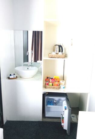 Imagen de la habitación del Hotel RedDoorz Premium at THE GRAND PENINSULA SUITES. Foto 22