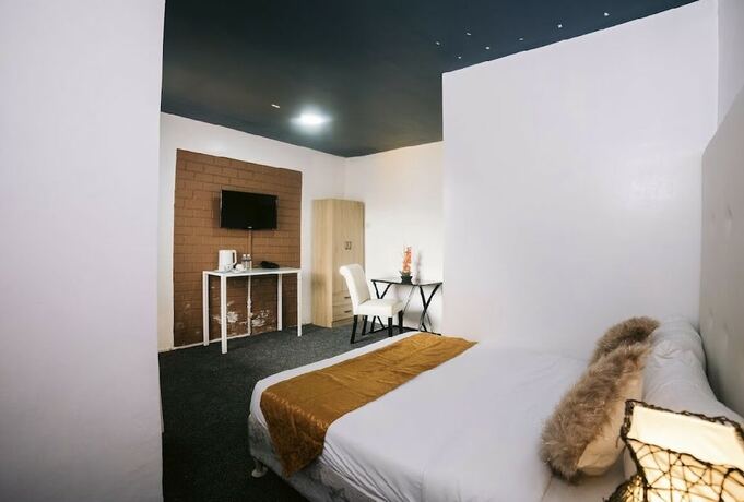 Imagen de la habitación del Hotel RedDoorz Premium at THE GRAND PENINSULA SUITES. Foto 30