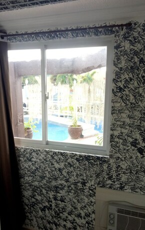 Imagen de la habitación del Hotel RedDoorz Premium at THE GRAND PENINSULA SUITES. Foto 32