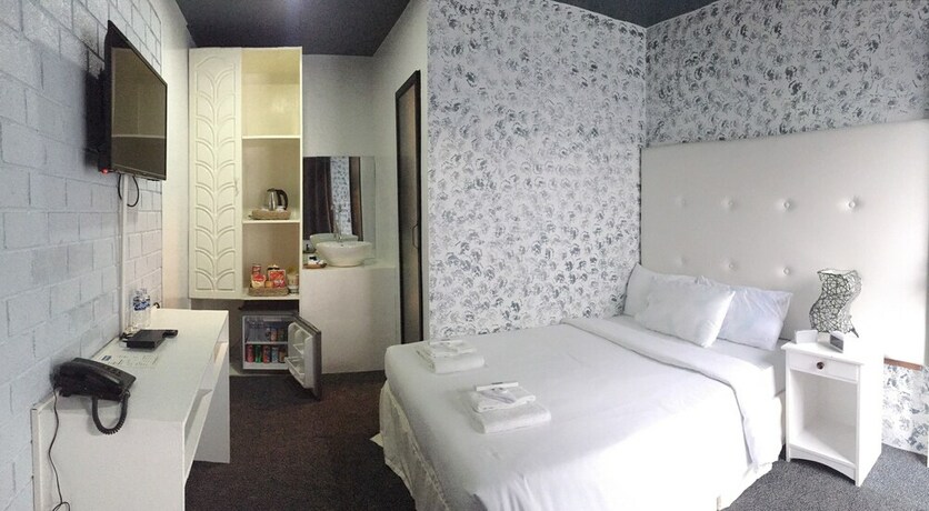Imagen de la habitación del Hotel RedDoorz Premium at THE GRAND PENINSULA SUITES. Foto 35