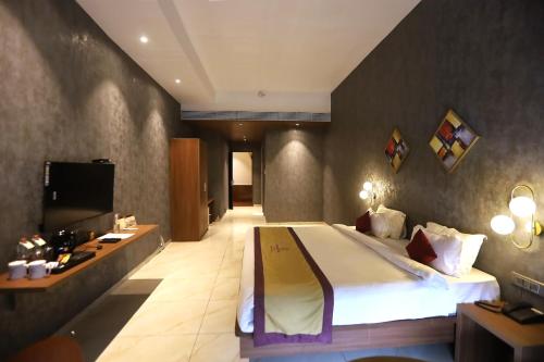 Imagen de la habitación del Hotel Reyansh Pride Boisar. Foto 18