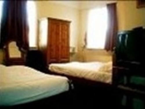 Imagen de la habitación del Hotel Rising Sun Hotel. Foto 8