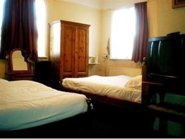 Imagen de la habitación del Hotel Rising Sun Hotel. Foto 10