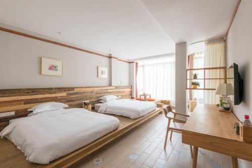 Imagen de la habitación del Hotel Ron Inn Xingping Hepan Xiaozhu. Foto 7