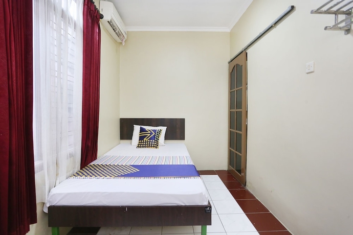 Imagen de la habitación del Hotel SPOT ON 2358 Aster Homestay. Foto 2