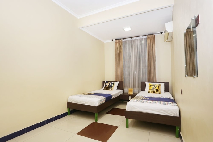 Imagen de la habitación del Hotel SPOT ON 2358 Aster Homestay. Foto 6