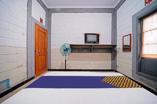 Imagen de la habitación del Hotel SPOT ON 91085 Griya Estu Wening. Foto 19