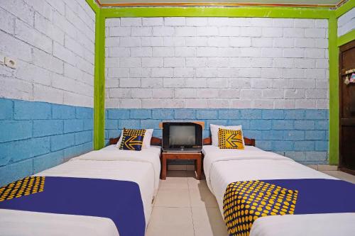 Imagen de la habitación del Hotel SPOT ON 91085 Griya Estu Wening. Foto 20