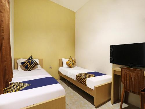 Imagen de la habitación del Hotel SPOT ON 91504 De Vila Ungu Syariah. Foto 20