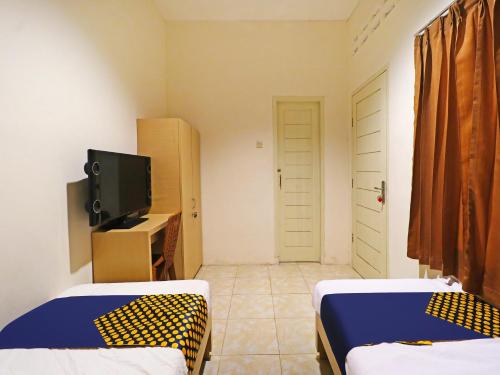 Imagen general del Hotel SPOT ON 91504 De Vila Ungu Syariah. Foto 15