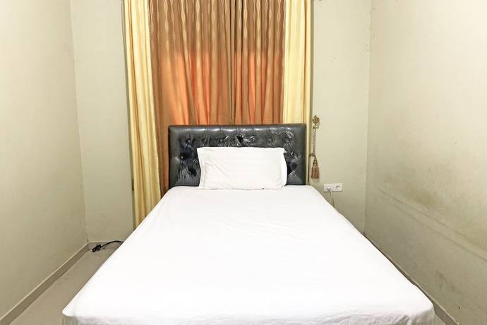 Imagen de la habitación del Hotel SPOT ON 92042 Sumber Rejo Homestay. Foto 11