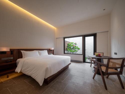 Imagen de la habitación del Hotel Sanhe Daoli Resort. Foto 12