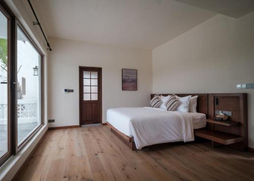 Imagen de la habitación del Hotel Sanhe Daoli Resort. Foto 14