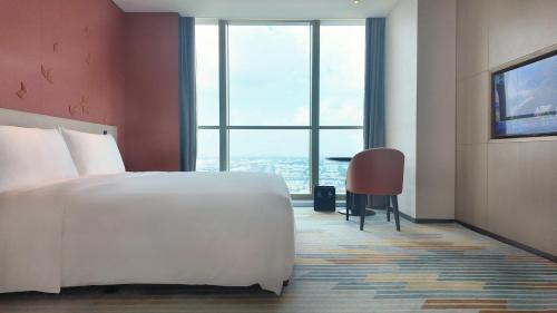 Imagen de la habitación del Hotel Shanghai Jinli Qube. Foto 19