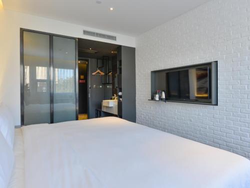 Imagen de la habitación del Hotel Shanghai Pudong Airport Chuansha Atour. Foto 8