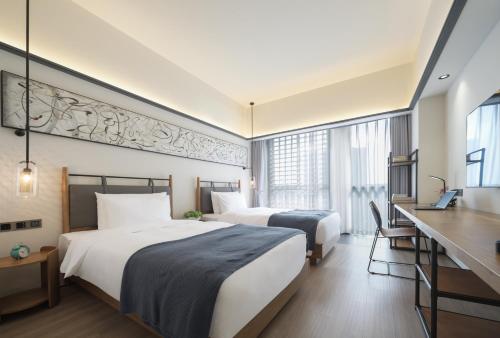 Imagen de la habitación del Hotel Shanghai T Plus Residence. Foto 18