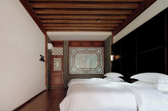 Imagen de la habitación del Hotel Shaxi Ancient Town Chang Le Li Chinese Courtyard. Foto 14