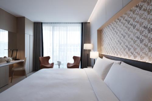 Imagen de la habitación del Hotel Shinhwa Jeju Shinhwa World Hotels and Resorts. Foto 7