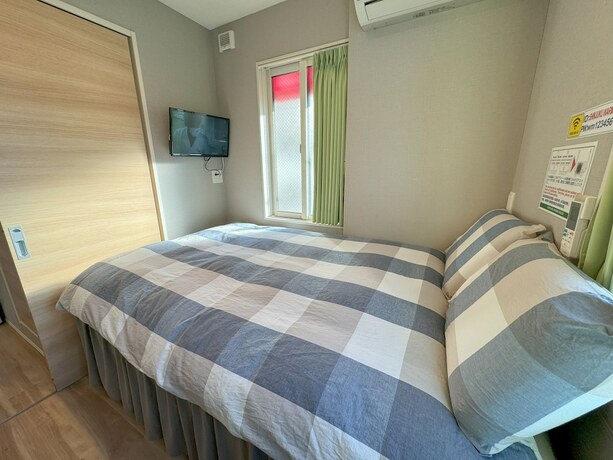 Imagen de la habitación del Hotel Shinjuku Warm House. Foto 16