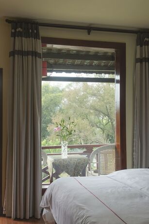 Imagen de la habitación del Hotel Snow Lion Riverside Resort. Foto 12