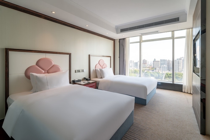Imagen de la habitación del Hotel Suning Universal Hotel. Foto 2