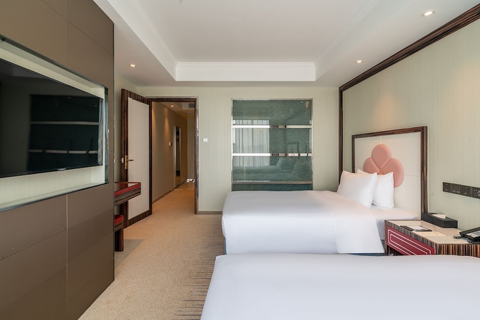Imagen de la habitación del Hotel Suning Universal Hotel. Foto 11