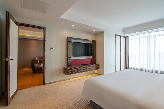 Imagen de la habitación del Hotel Suning Universal Hotel. Foto 14