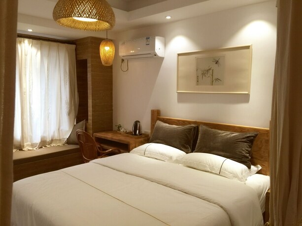 Imagen de la habitación del Hotel Suzhou Leisure Guest House. Foto 11