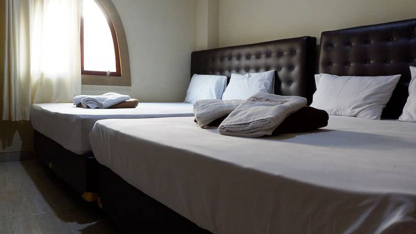 Imagen de la habitación del Hotel Syariah Larismanis. Foto 8