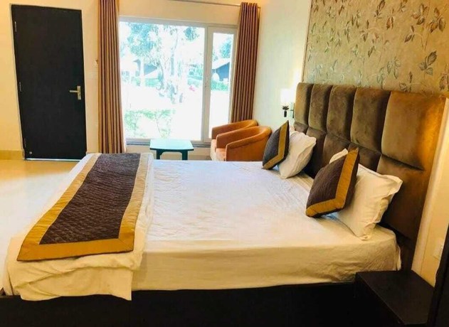 Imagen de la habitación del Hotel THE PALMS RESORT, Dehradun. Foto 11
