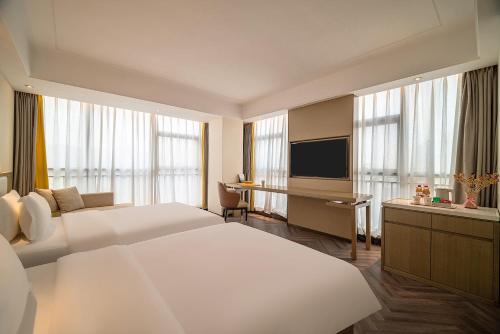 Imagen de la habitación del Hotel TOWO Shangpin International. Foto 19