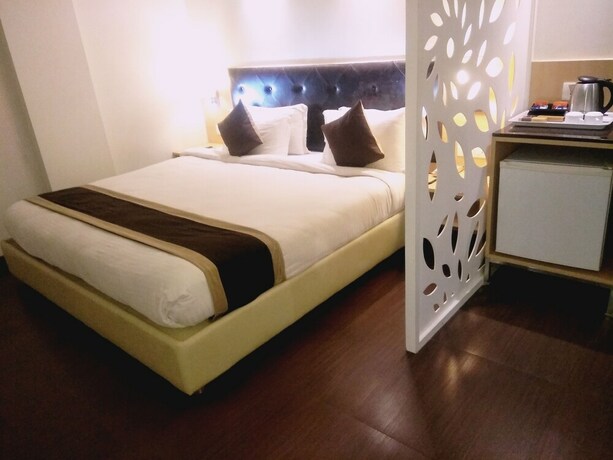Imagen de la habitación del Hotel The Blossom. Foto 19