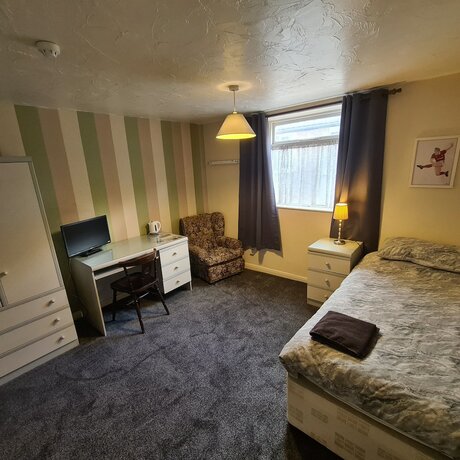 Imagen de la habitación del Hotel The Coach House Rooms. Foto 12