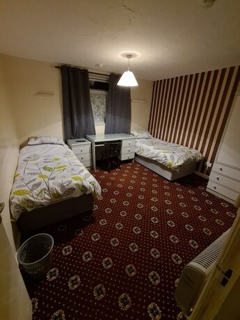 Imagen de la habitación del Hotel The Coach House Rooms. Foto 14