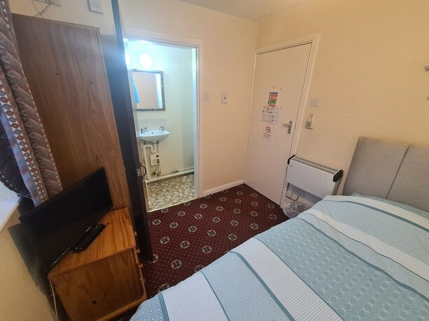 Imagen de la habitación del Hotel The Coach House Rooms. Foto 15