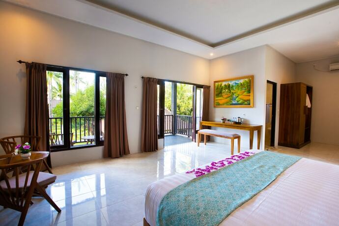 Imagen de la habitación del Hotel The Kirana Tembok. Foto 19