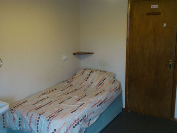 Imagen de la habitación del Hotel The Lodge Guesthouse. Foto 6