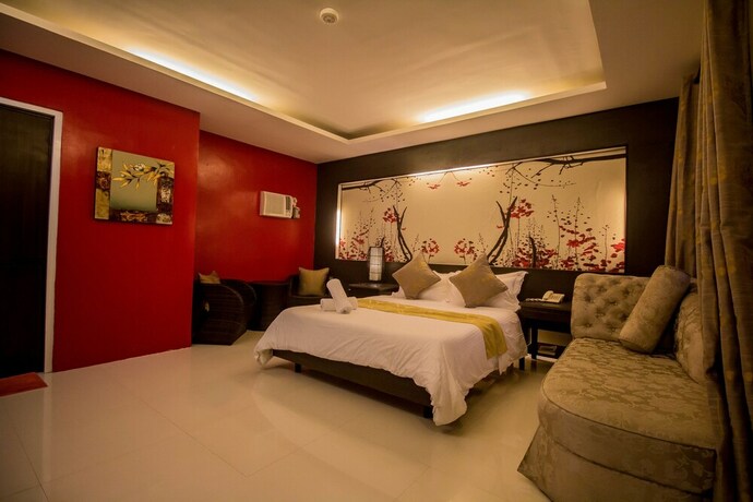 Imagen de la habitación del Hotel The Red Palm Suites And Restaurant. Foto 16