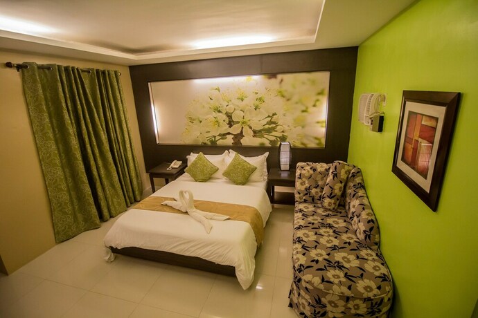 Imagen de la habitación del Hotel The Red Palm Suites And Restaurant. Foto 20