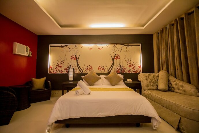 Imagen de la habitación del Hotel The Red Palm Suites And Restaurant. Foto 25