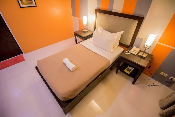 Imagen de la habitación del Hotel The Red Palm Suites And Restaurant. Foto 26