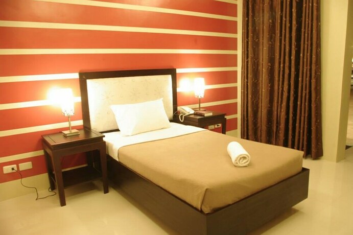 Imagen de la habitación del Hotel The Red Palm Suites And Restaurant. Foto 27